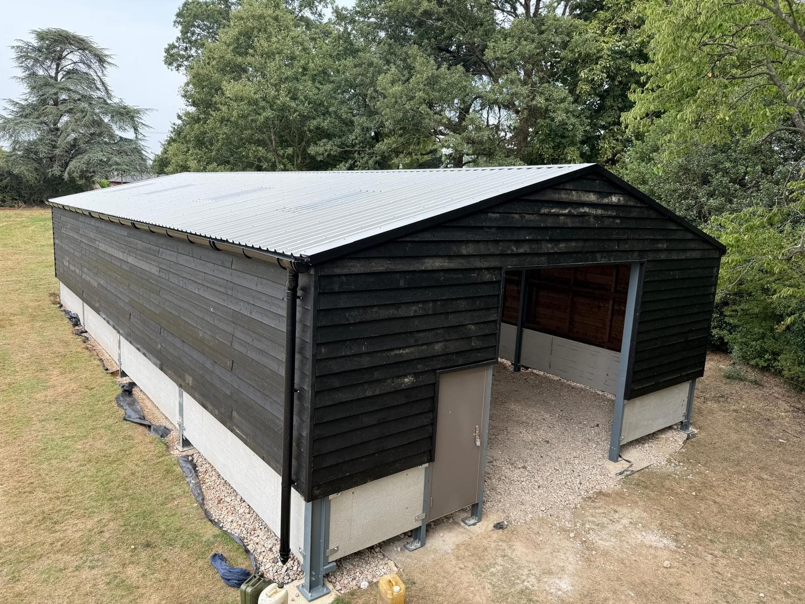 Completed agricultural steel building with black cladding